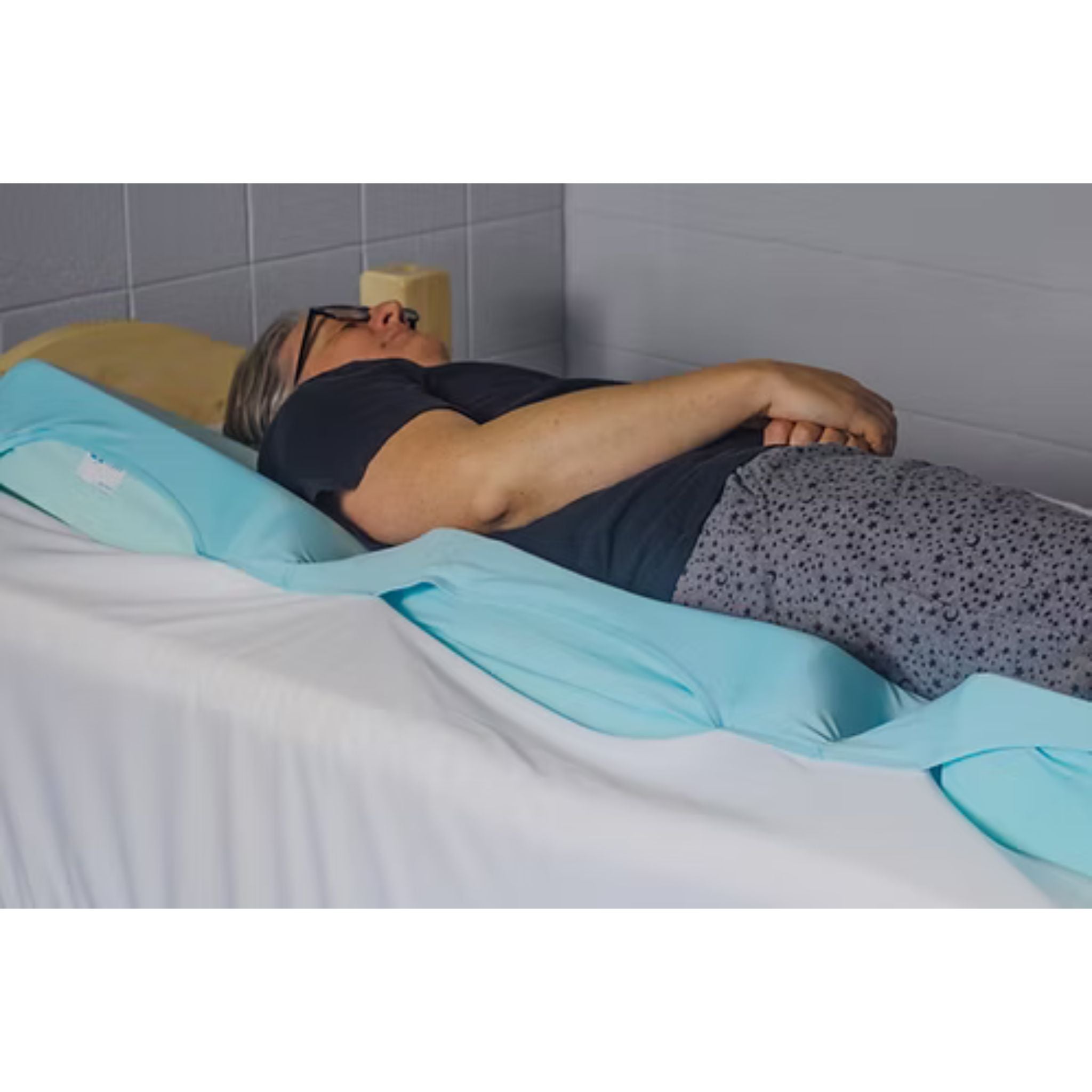 Patient resting comfortably on the Cloud 9 Care wedge positioning system for improved alignment