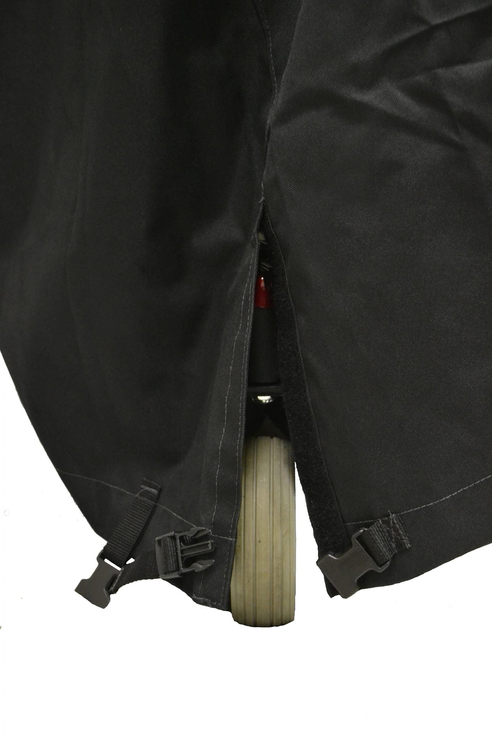 Diestco 4-corner slit power wheelchair cover with a corner slit open around the wheel and tie-down hardware