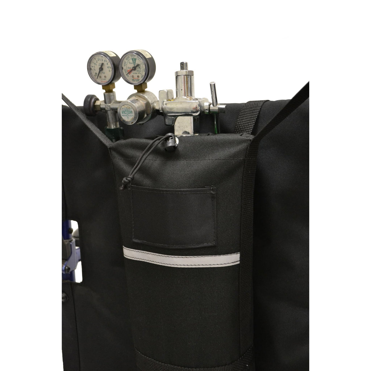 Close-up of the Diestco E-Tank Holder on a wheelchair showing the drawstring top around the cylinder regulator, ID pocket, and reflective strip