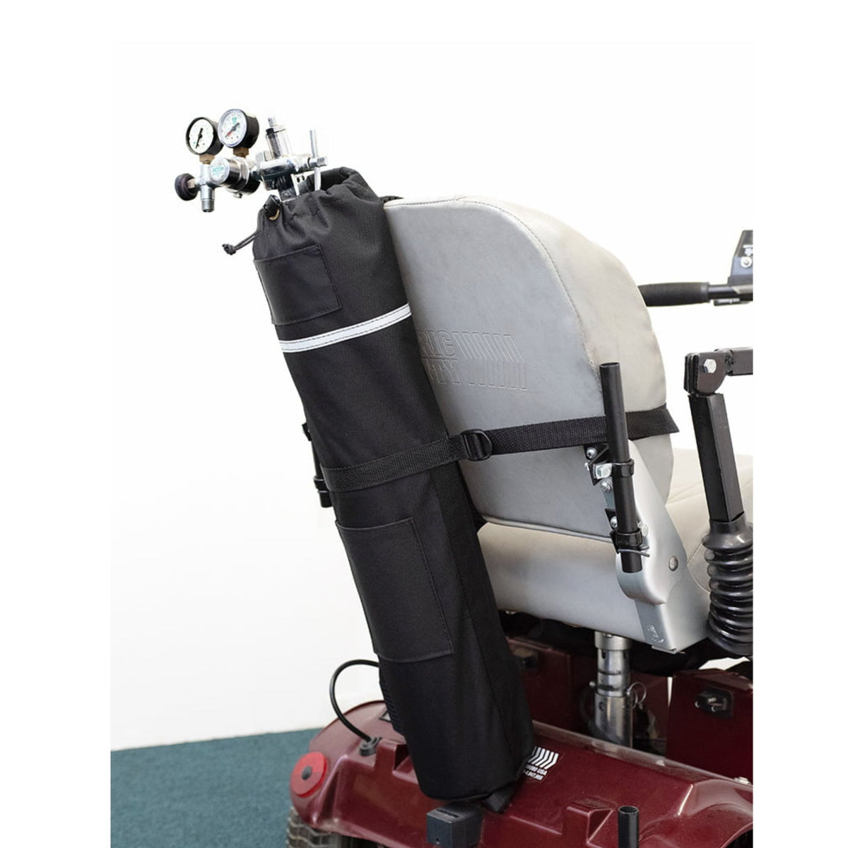 Diestco E-Tank Holder strapped to a power wheelchair seatback, holding an E oxygen cylinder upright with the regulator at the top, drawstring closure, ID pocket, and reflective strip