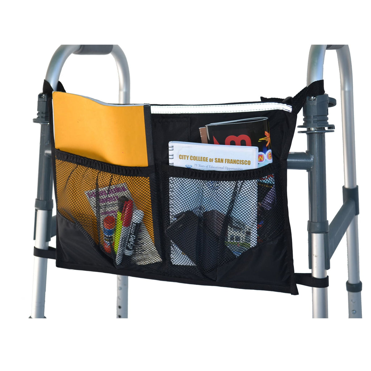 Diestco Front Walker Bag spanning the front of a folding walker, loaded with a folder, notebook, and magazine in the main compartment and pens and small items in the two front mesh pockets