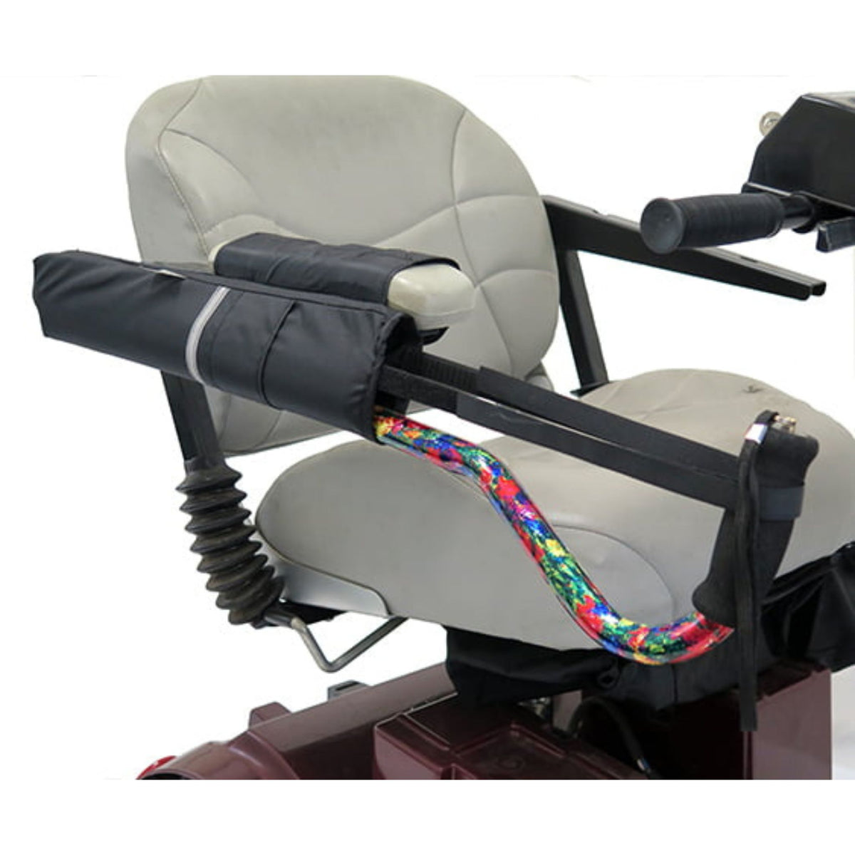 Diestco Cane Holder in horizontal mount strapped along a mobility scooter armrest, holding an offset cane flat with reflective strip