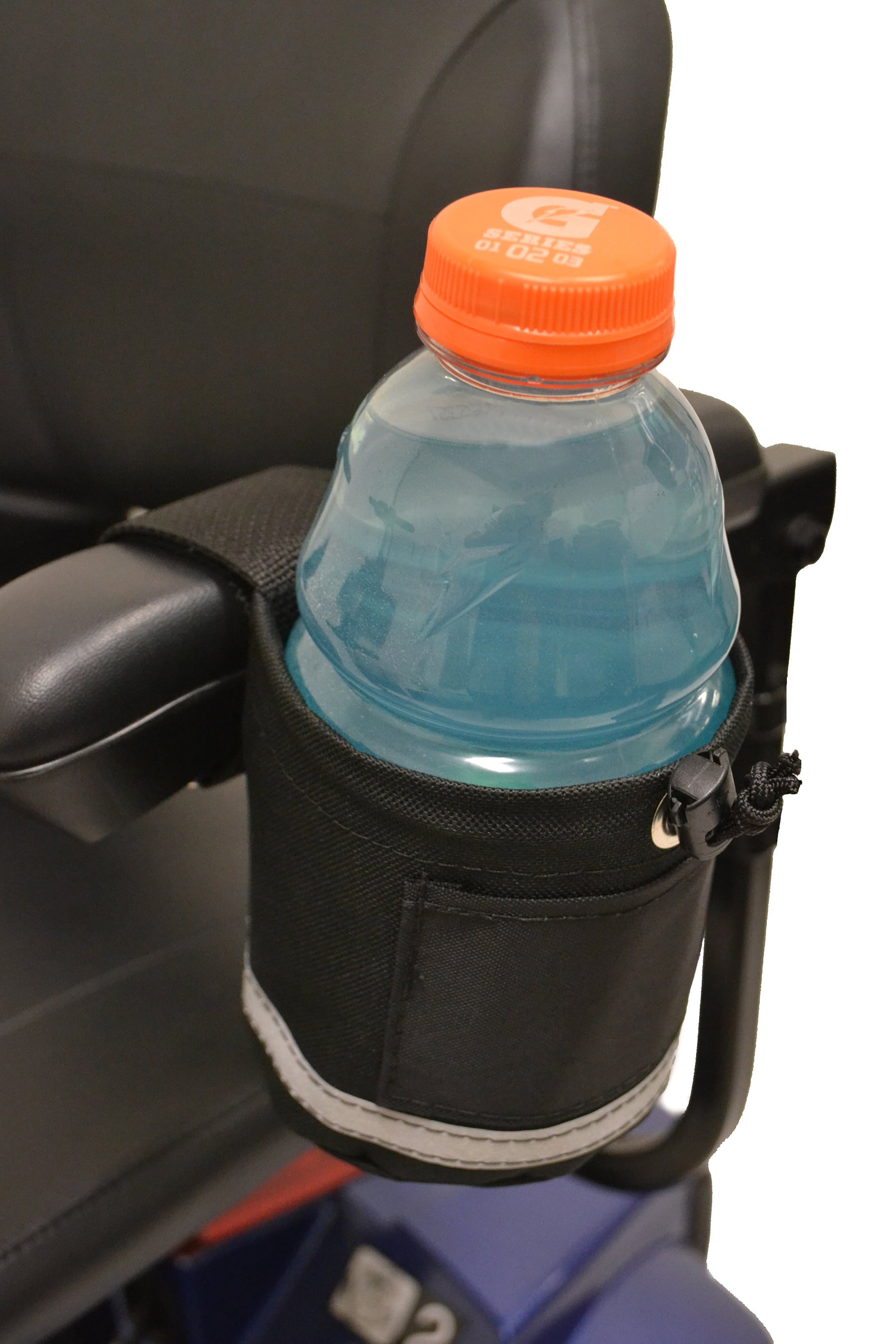 Diestco horizontal grip cupholder attached to a power wheelchair armrest holding a 32 oz sports drink bottle