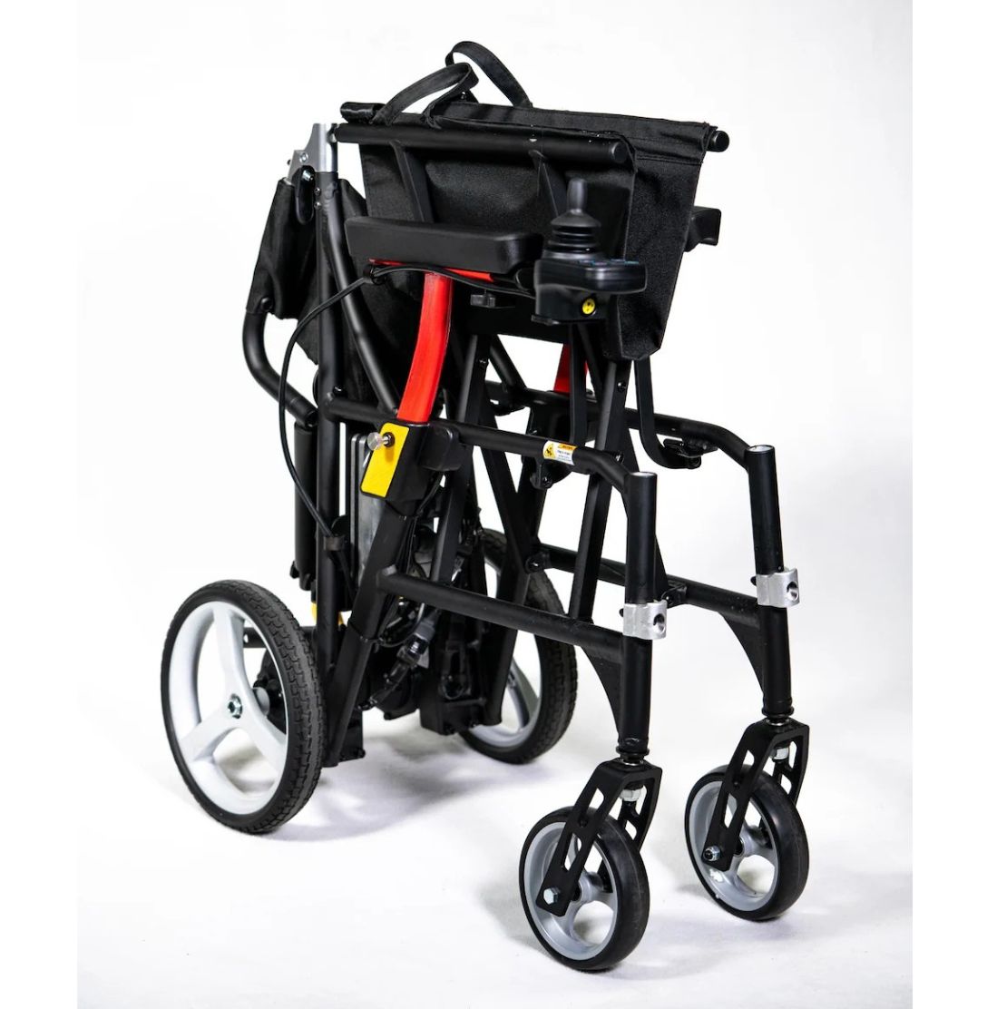 Feather Power Chair folded in one piece to 13 inches wide, with joystick and armrest still attached