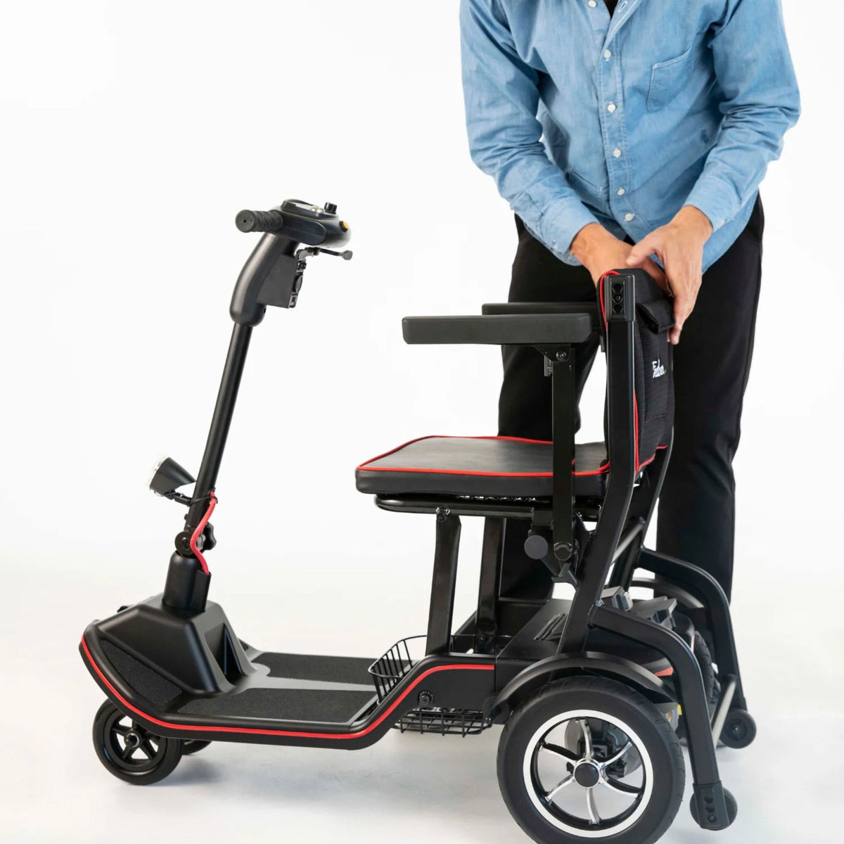 Man beginning to fold the Feather Scooter by pulling the fold knob and lowering the seatback
