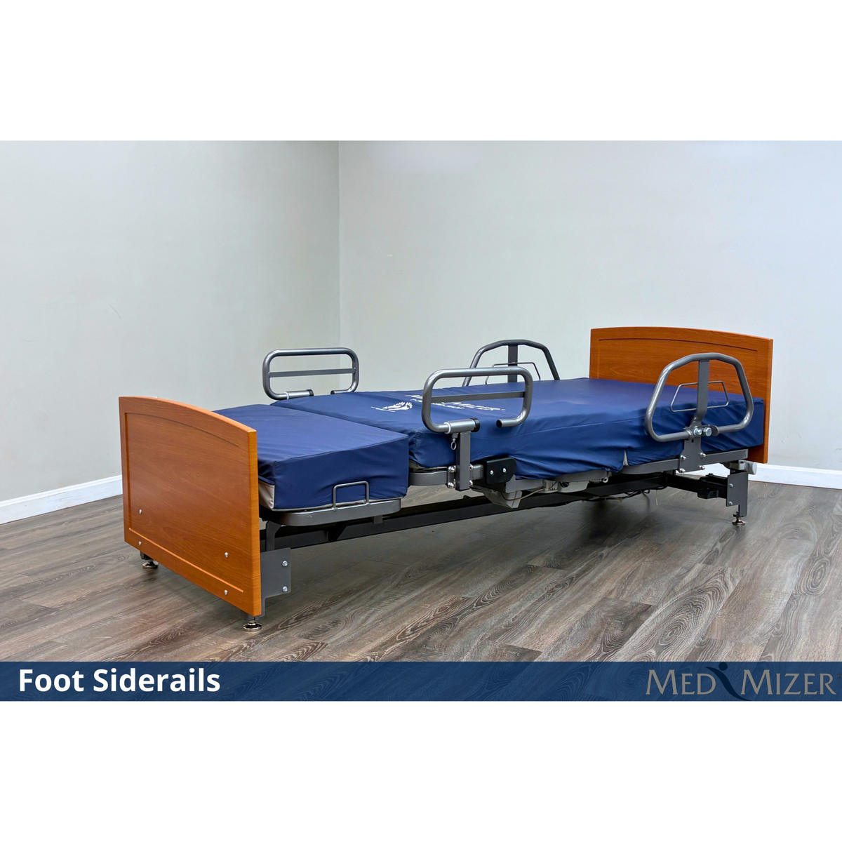 Med-Mizer ActiveCare Fixed bed lying flat with foot siderails and half-length assist rails on a blue mattress