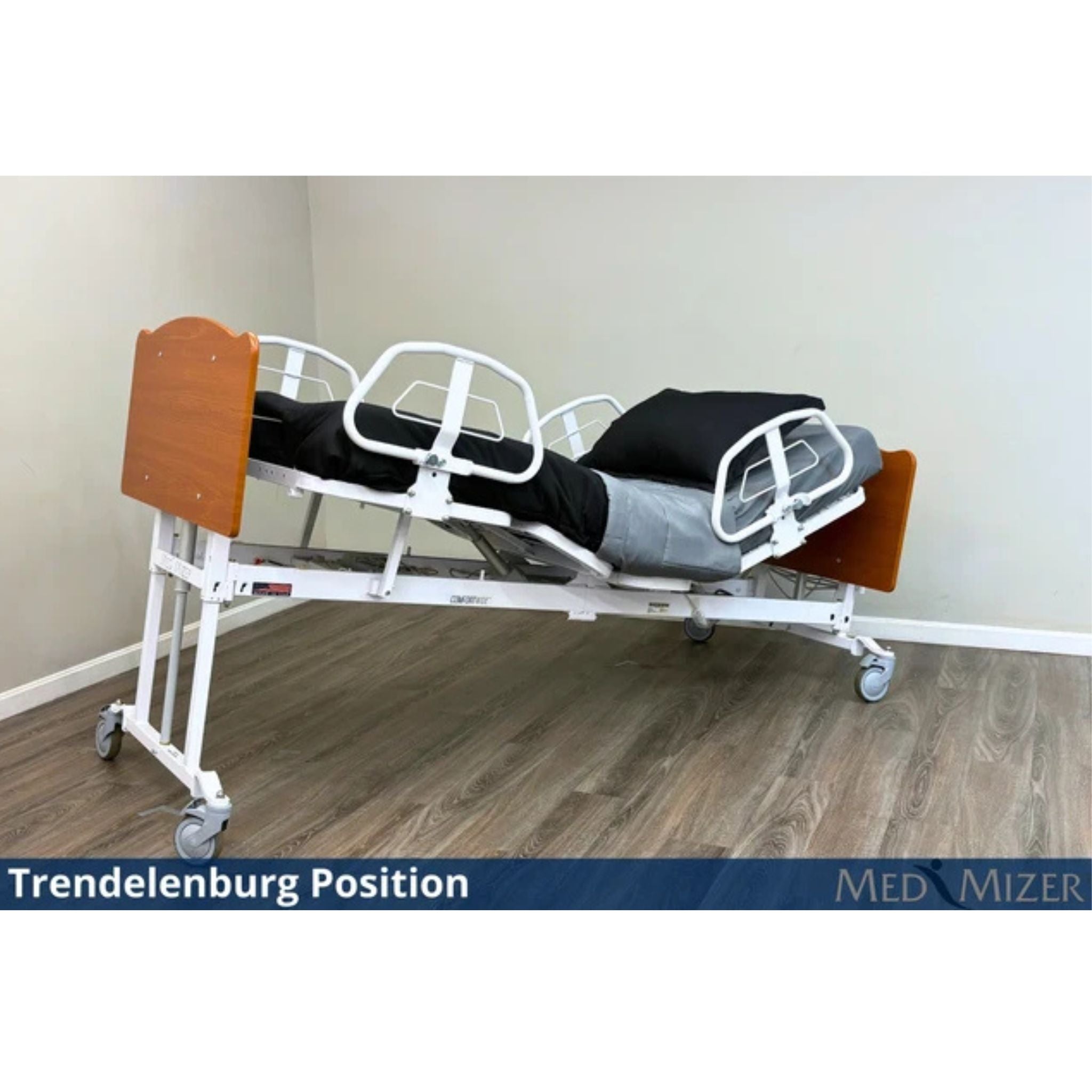 Med-Mizer ComfortWide expandable bed tilted into the Trendelenburg position with side rails and mattress