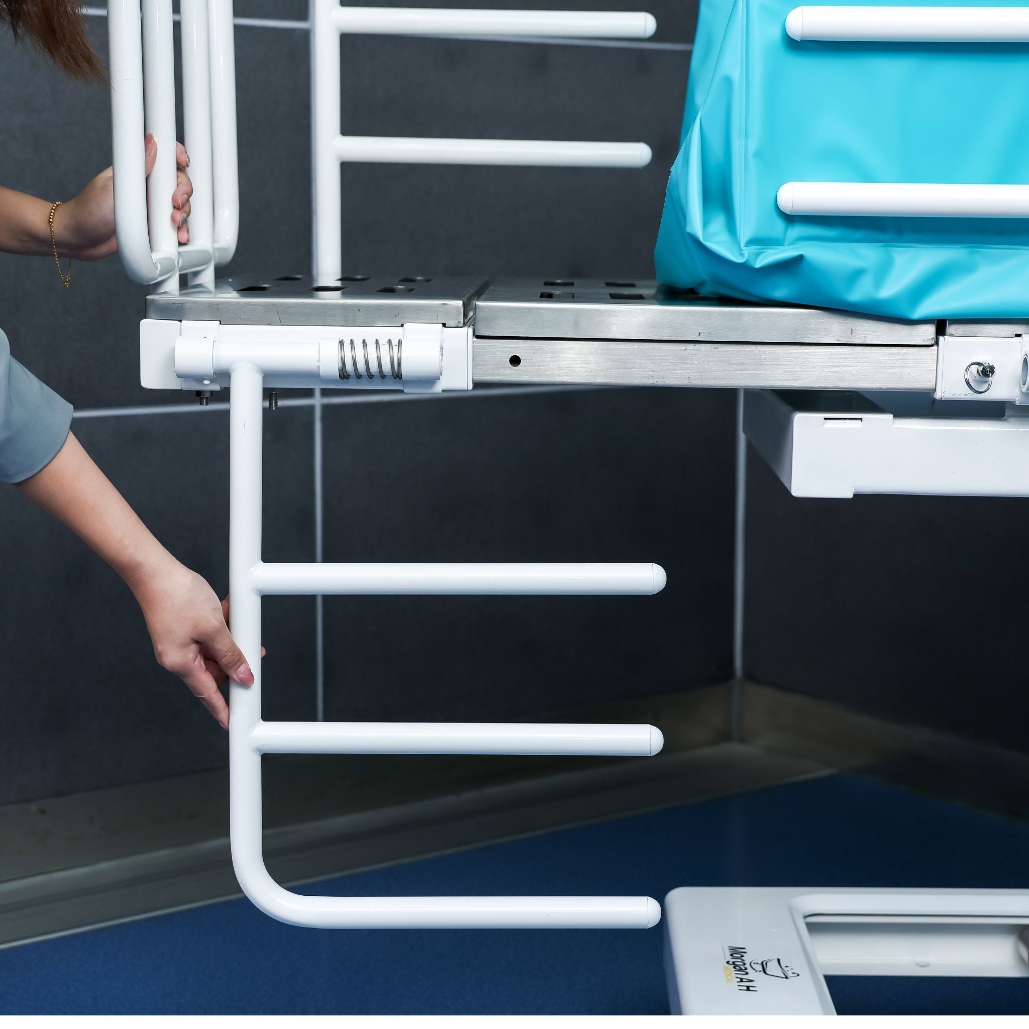 Fold-down side rail on Morgan AH Medical bathing trolley for caregiver access