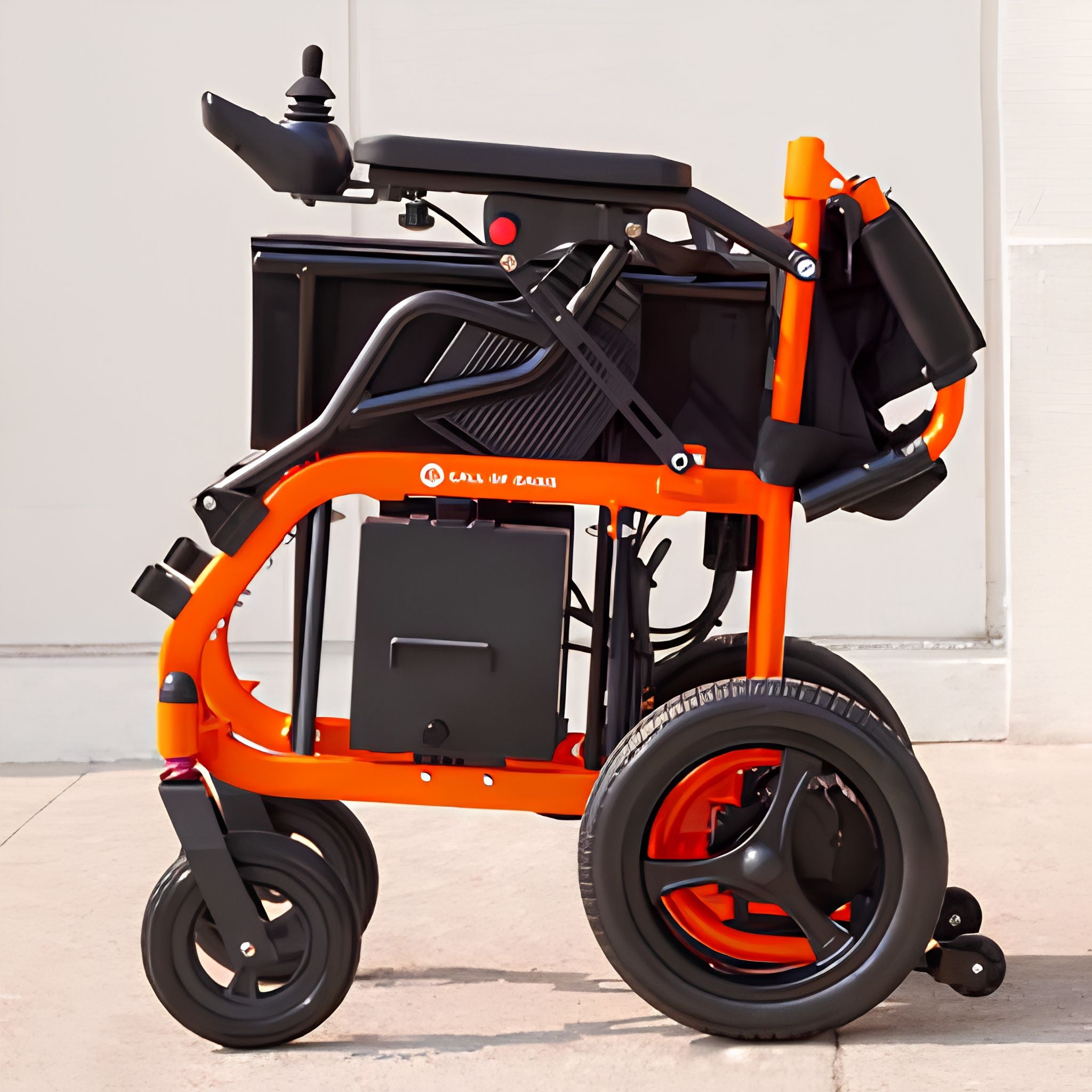 Orange OAS Air Ultra electric wheelchair folded into a compact upright shape for travel and storage
