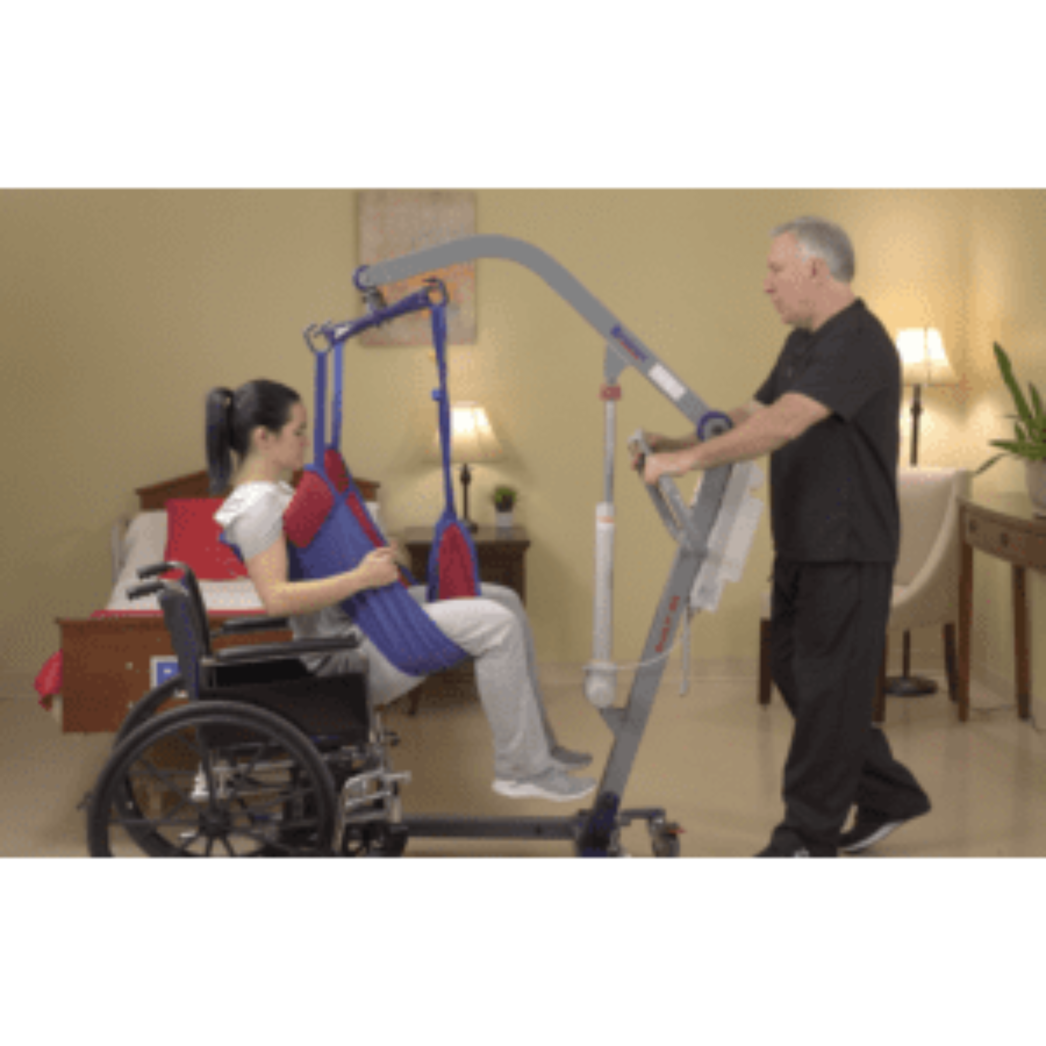 Patient lift transferring a woman from wheelchair in a home care setting