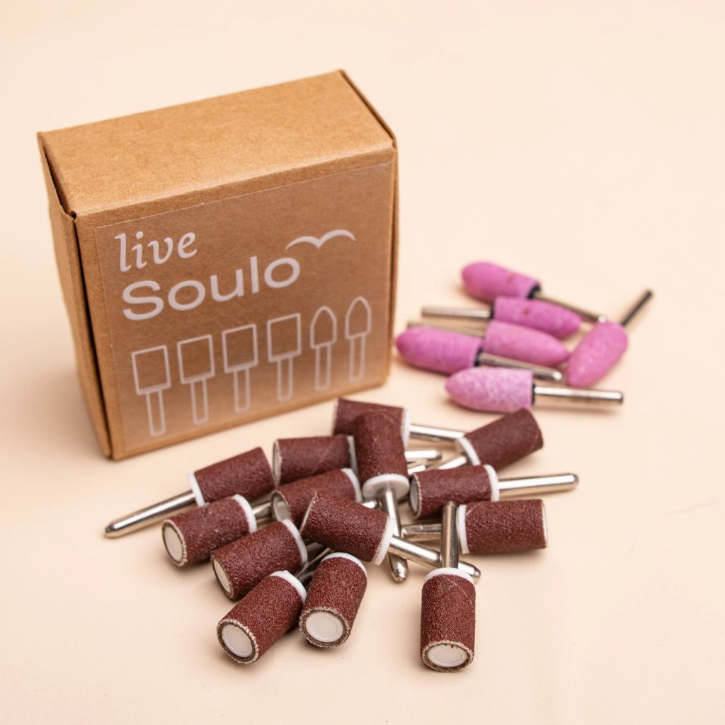 Soulo replacement tips 12-month supply with sanding bands and grinding stone tips beside a live Soulo box