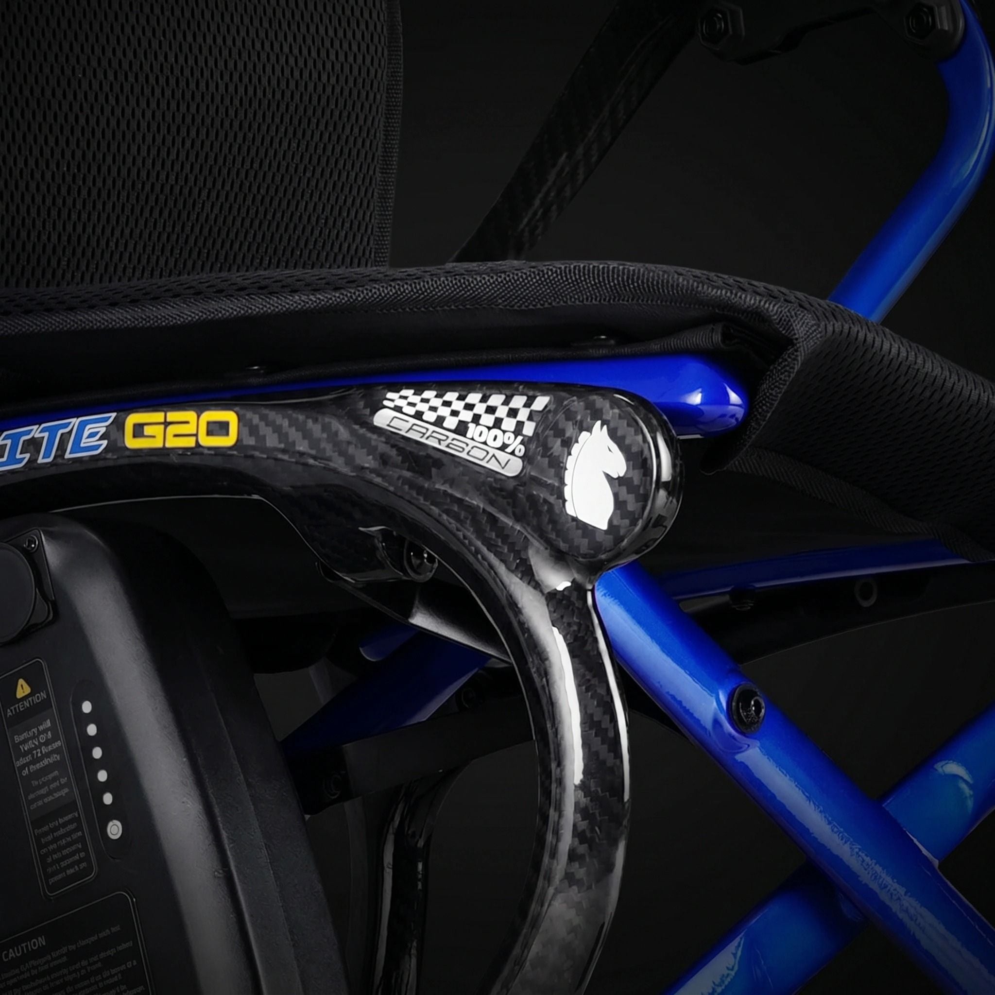 Close-up detail of the Ultralite G20 carbon fiber electric wheelchair frame showing lightweight carbon fiber construction, reinforced support structure, and premium mobility engineering design