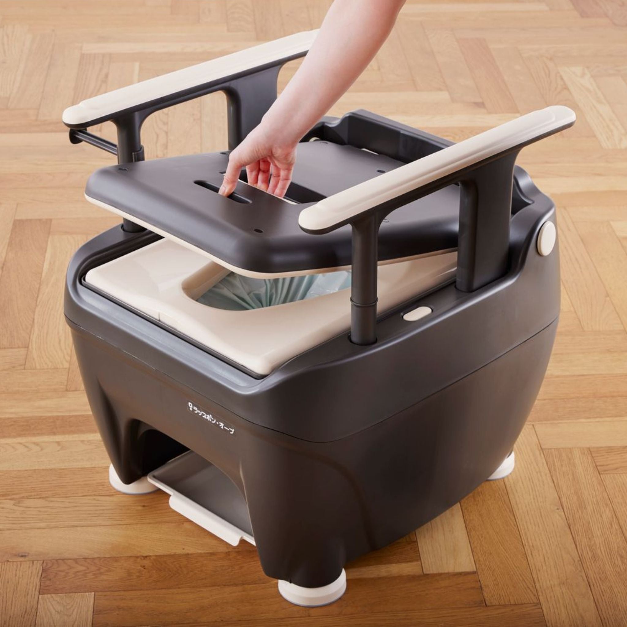 Top access lid on the Wrappon ORB auto-wrapping portable commode toilet for simplified maintenance and hygienic waste system access