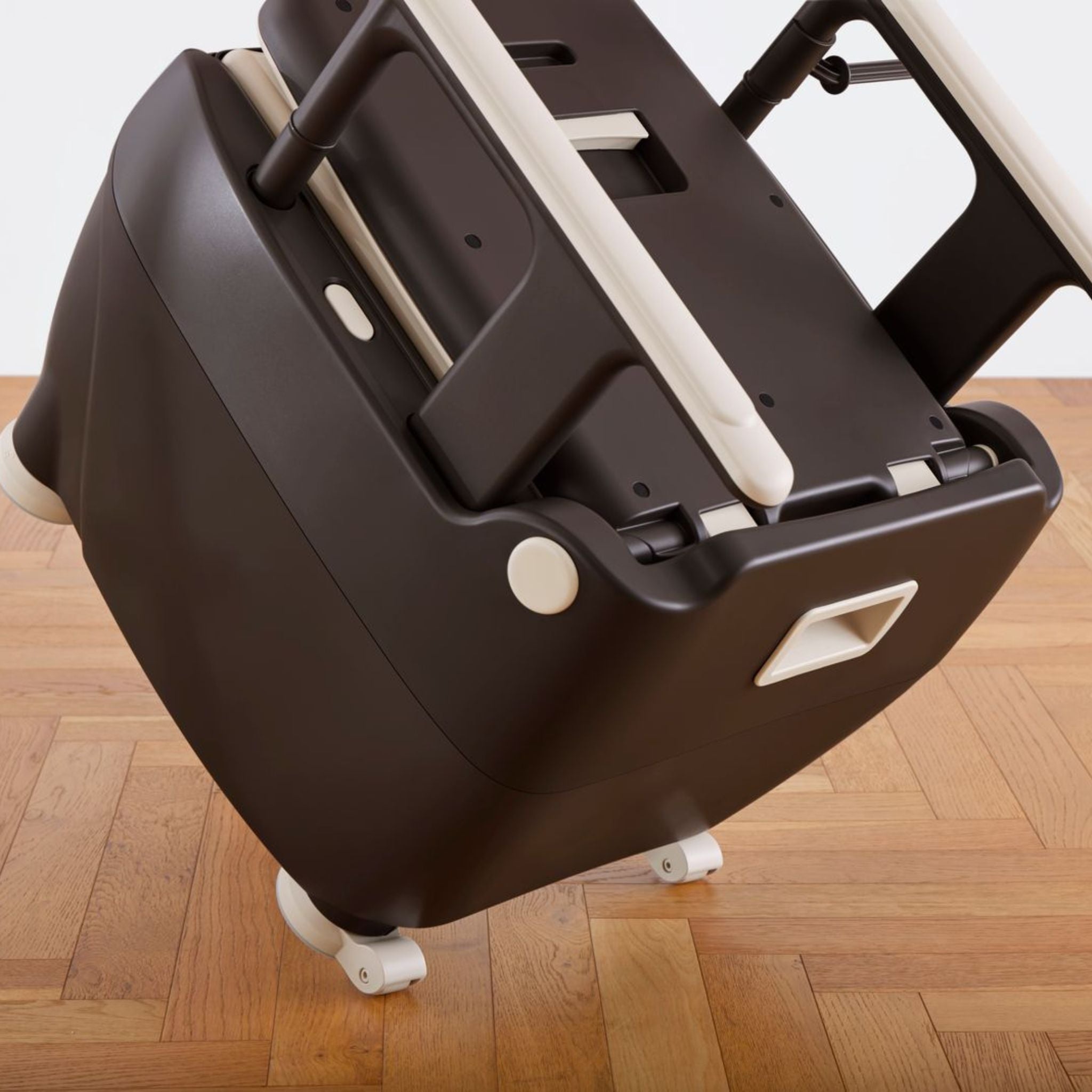 Wrappon ORB bedside commode tilted for transport using integrated mobility wheels for easier repositioning