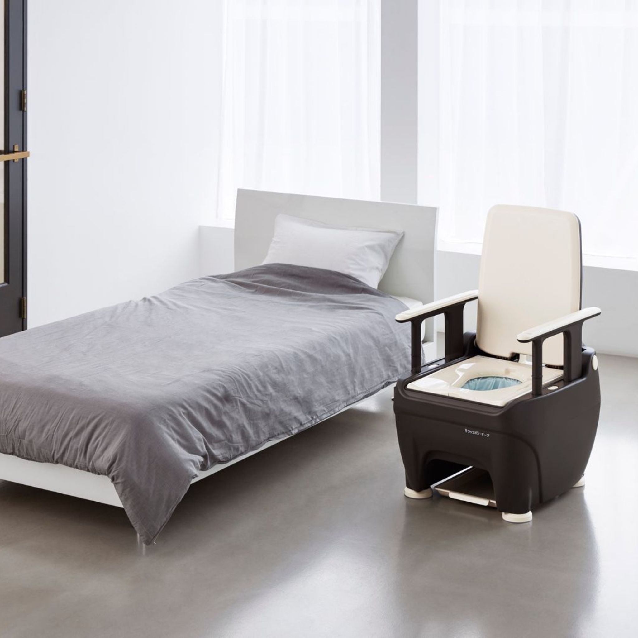 Wrappon ORB waterless bedside commode toilet positioned beside a bed for nighttime home care and aging in place support