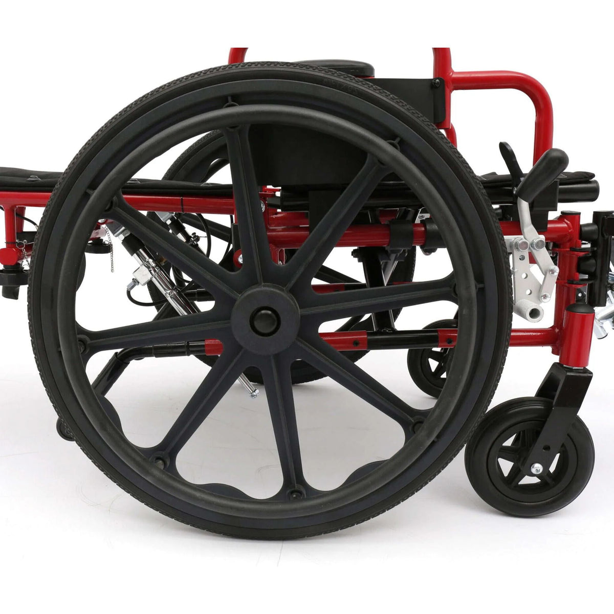 Close-up of red Ziggo Pro wheelchair quick-release rear wheel with handrim, front caster and backrest reclined flat