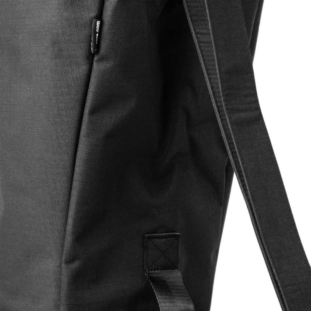 Close-up of the black byACRE Carbon Overland travel bag padded polyester, shoulder strap, and reinforced tab