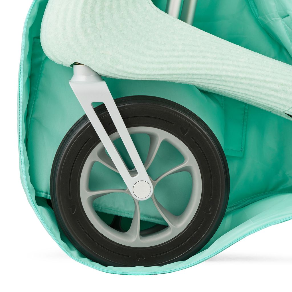 Close-up of a Nordic Pioneer front wheel and fork padded inside the Glacier Green byACRE travel bag
