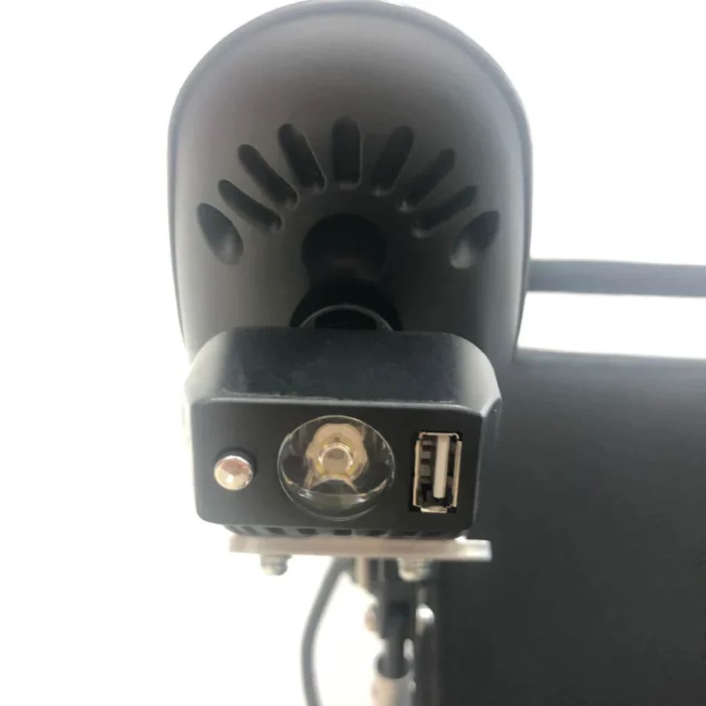 Close-up of the ComfyGo headlight face showing the LED bulb, light switch, and USB charging port