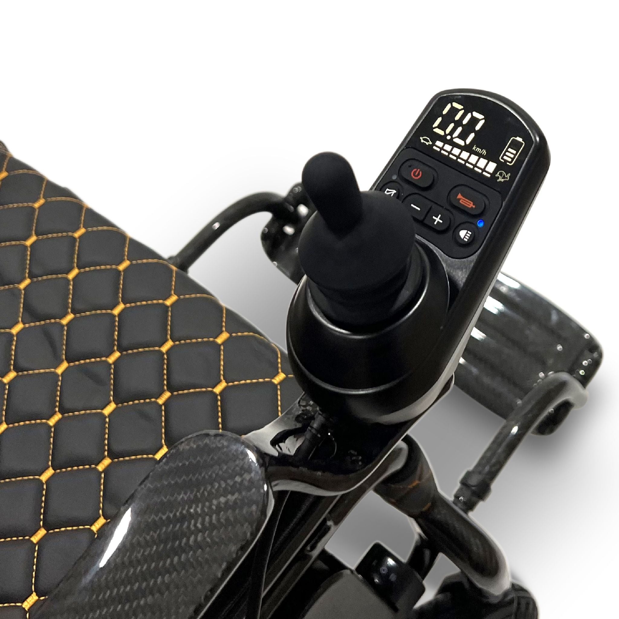 Close-up of the ComfyGO Phoenix Carbon electric wheelchair joystick controller with digital display, speed controls, horn button, and carbon fiber armrest detail.