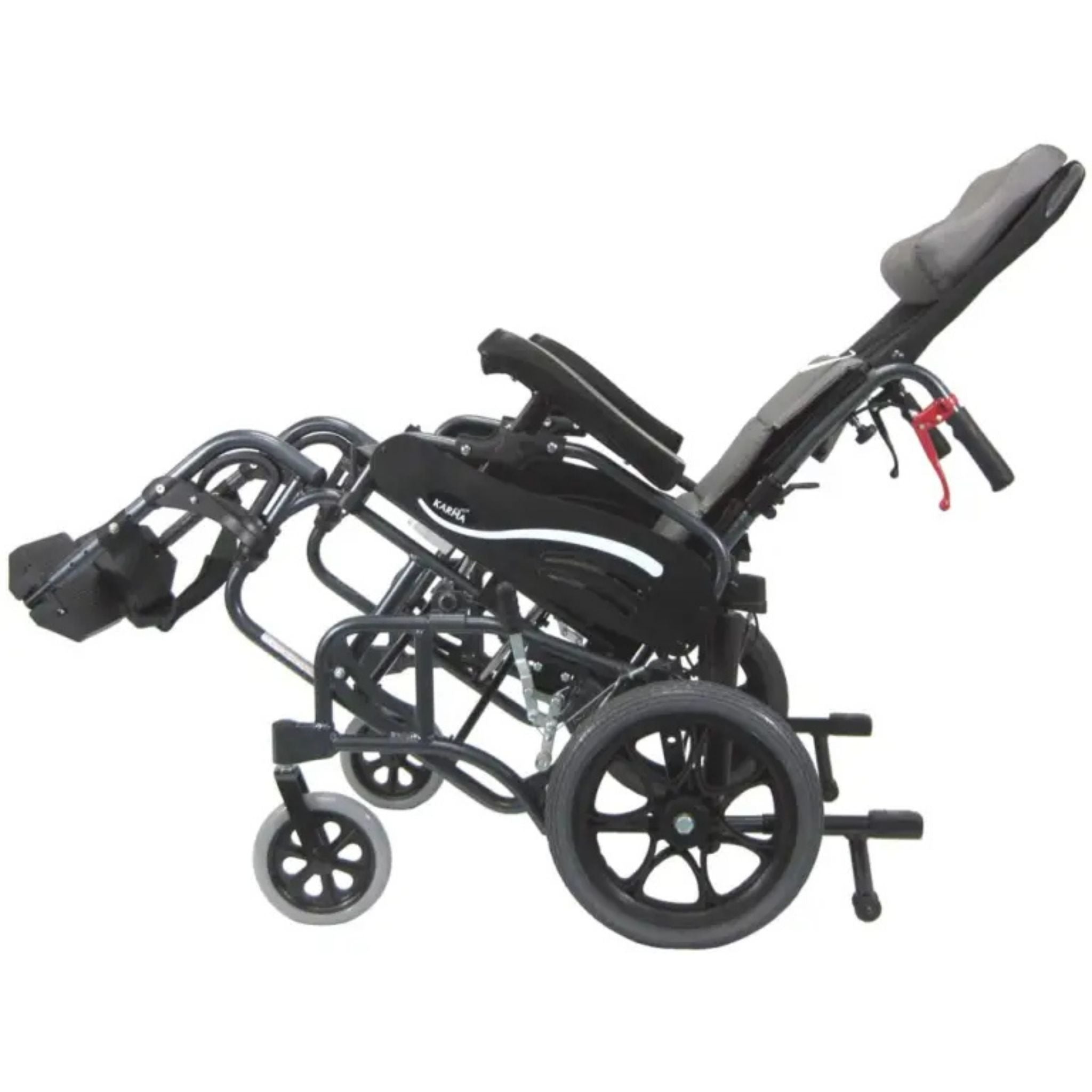 Side profile of the Karman VIP-515-TP reclining tilt-in-space wheelchair with elevated leg rests, padded headrest, and full tilt positioning on a white background