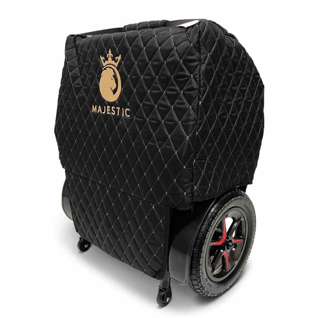 Left angled view of the Majestic quilted travel bag fitted over a folded power wheelchair with rear wheel visible
