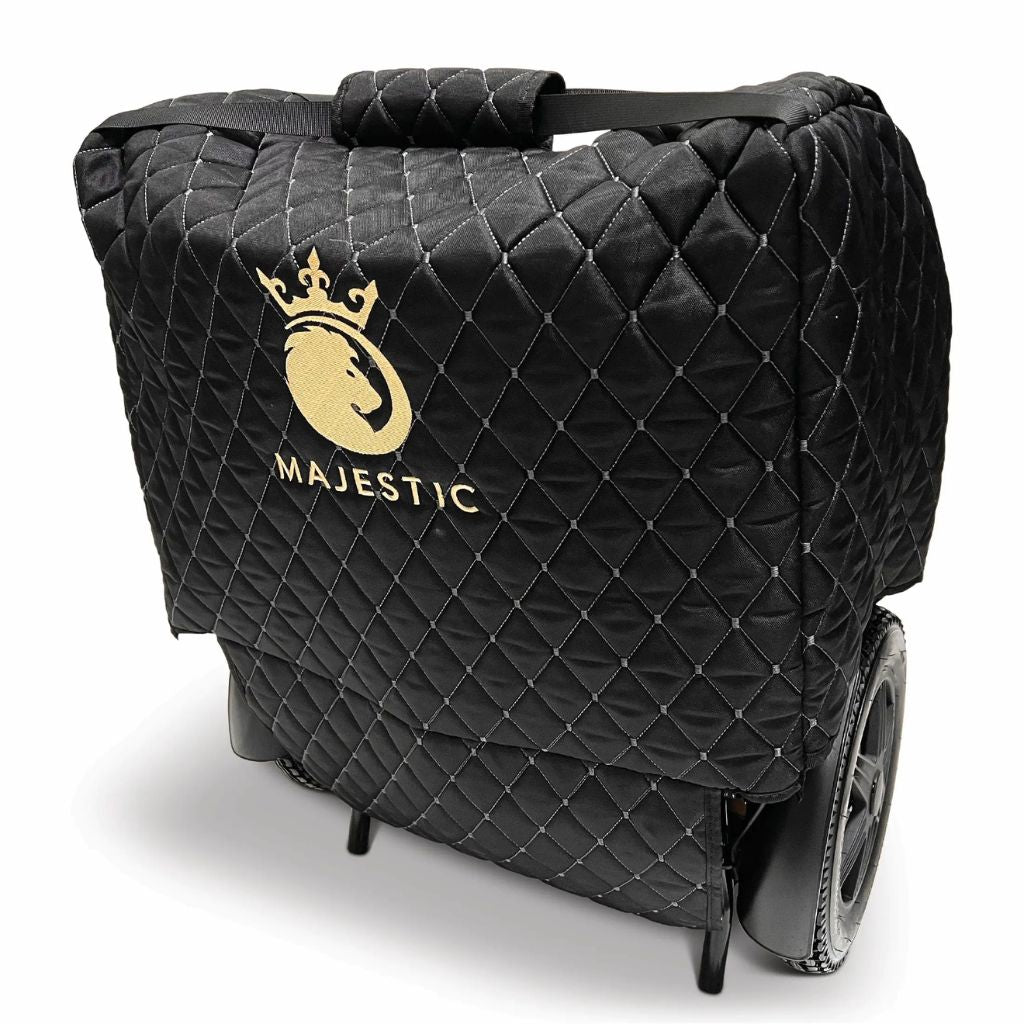 Angled view of the Majestic travel bag on a folded wheelchair, showing the padded top carry handle and shoulder strap