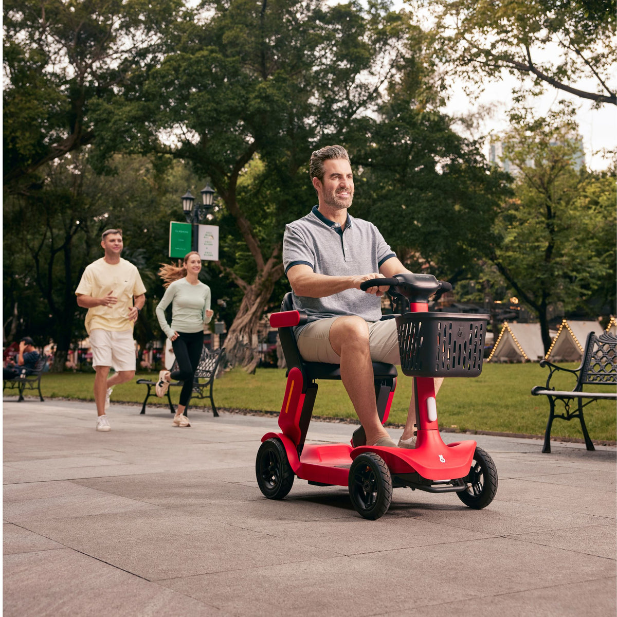 Man riding the Paiseec S3 in Red along a tree-lined park path