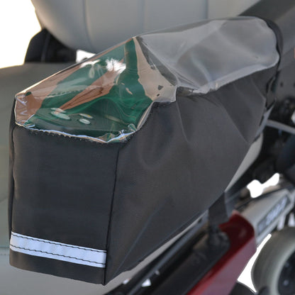 Diestco joystick cover installed on a power wheelchair armrest with the green joystick visible through the clear window and reflective tape along the bottom edge