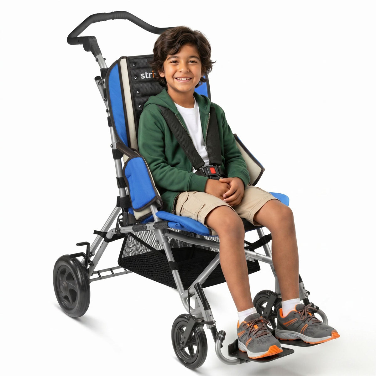 Smiling boy seated in a blue Circle Specialty Strive EZ adaptive stroller with 5-point harness, footplates, and under-seat basket