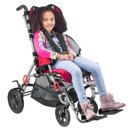 Smiling girl in a red Circle Specialty Strive adaptive stroller with 5-point harness, shown with optional basket and transit brackets