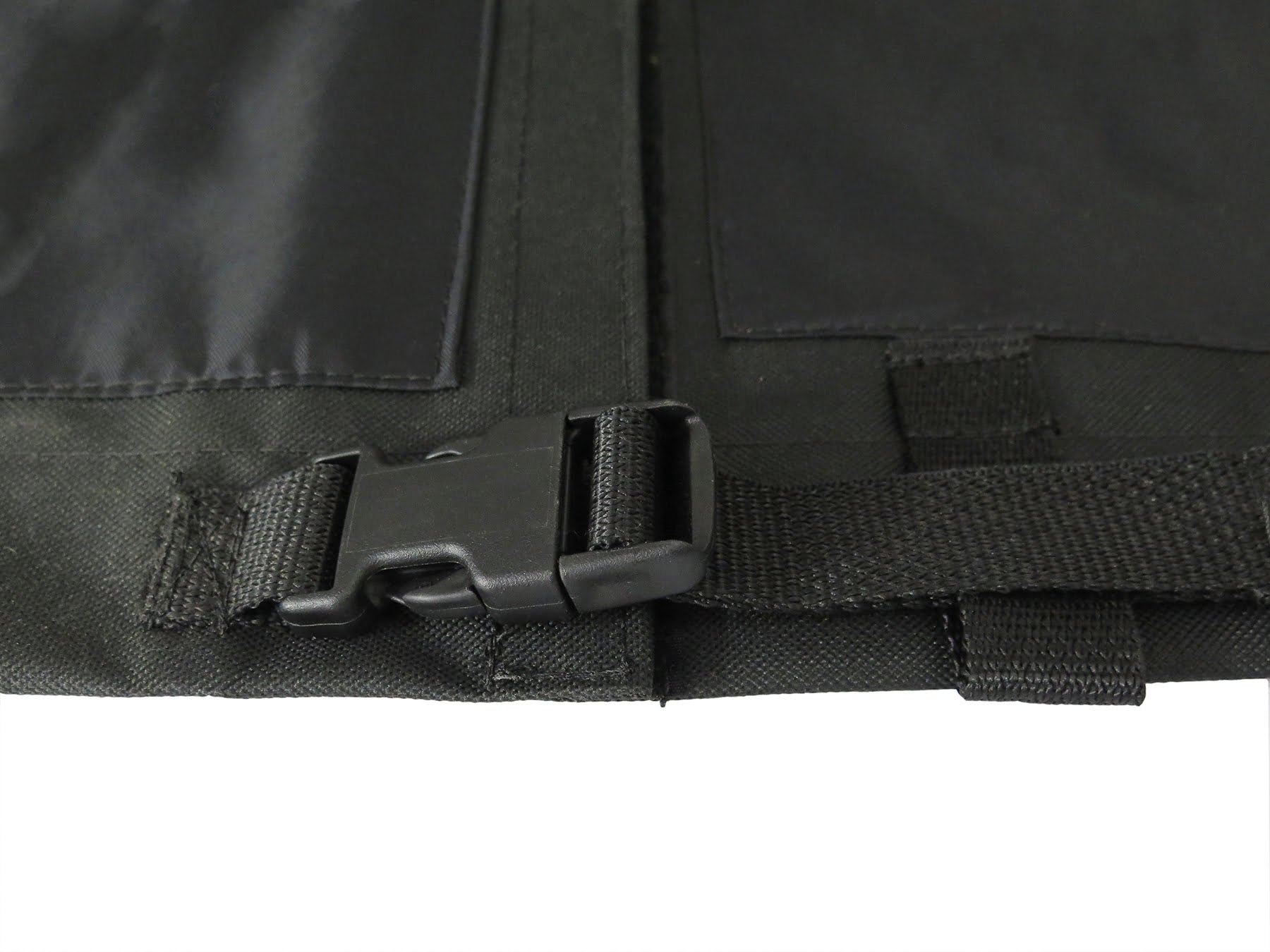 Close-up of the Diestco 4-corner slit mobility scooter cover's side-release buckle and webbing strap at a corner