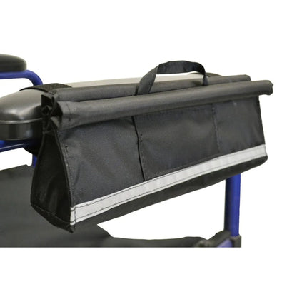 Diestco Armrest Pocket strapped to a manual wheelchair armrest with hook-and-loop, showing the slim profile, front pocket, and reflective strip