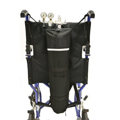 Diestco E-Tank Holder looped around the push handles of a manual wheelchair, carrying an E oxygen cylinder upright behind the seatback with regulator and gauges at the top