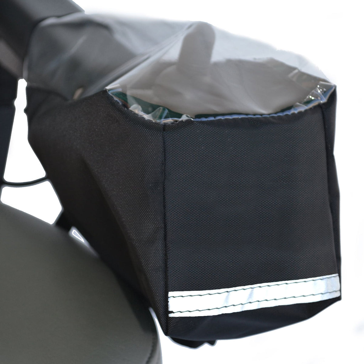 Diestco power wheelchair joystick cover in black water-resistant fabric with clear vinyl window over the controls and reflective strip, shown mounted on an armrest