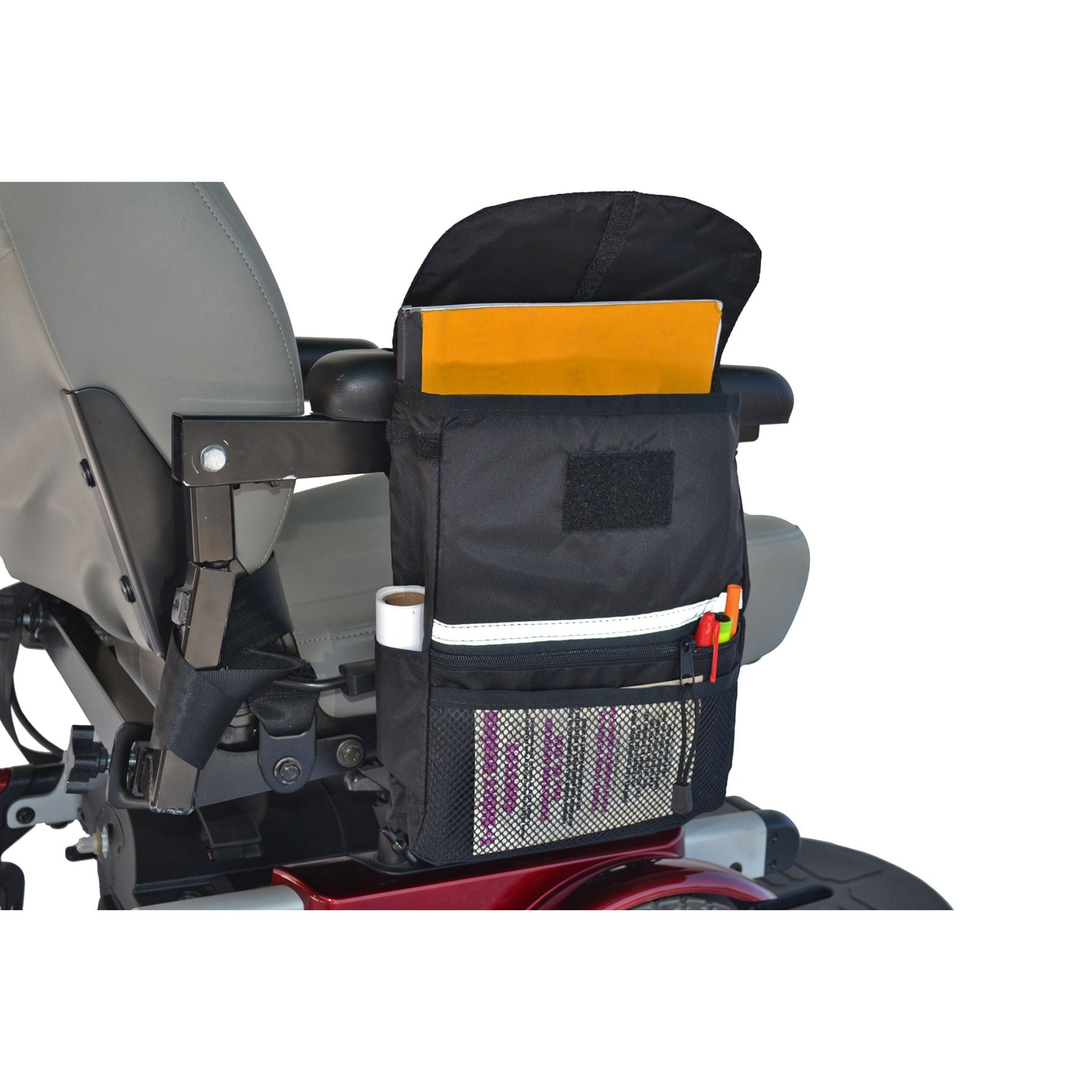 Diestco Large Saddle Bag strapped to a power wheelchair armrest holding a book and pens, sitting clear of the wheels