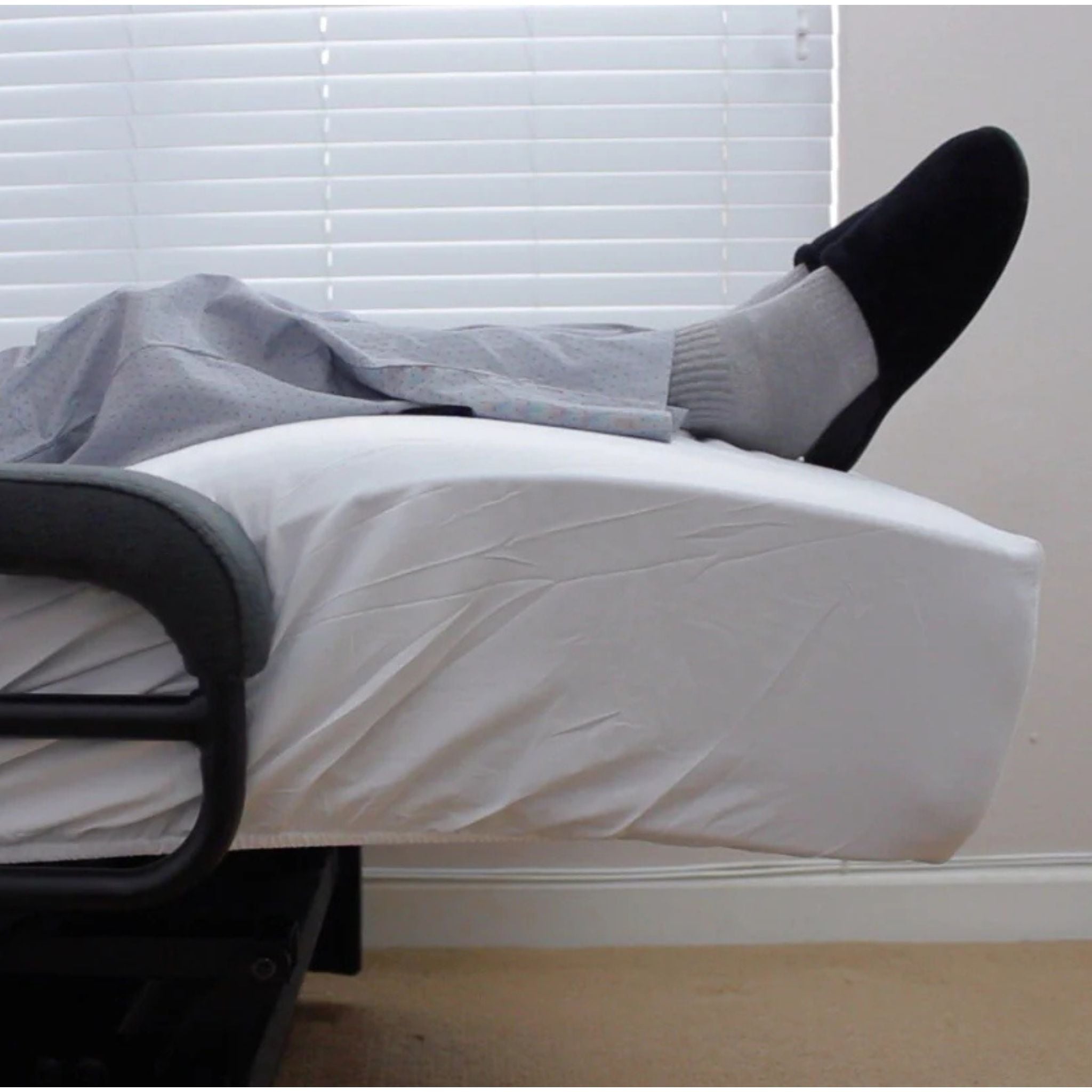 Close-up of the ENVYY Sleep-to-Stand adjustable bed by Platinum Health with elevated lower-leg positioning to support comfort, pressure redistribution, and relaxed resting posture in a home bedroom setting.