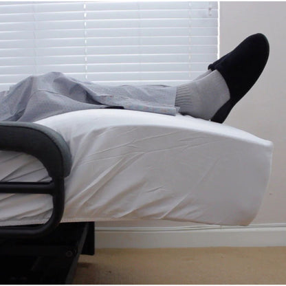 Close-up of the ENVYY Sleep-to-Stand adjustable bed by Platinum Health with elevated lower-leg positioning to support comfort, pressure redistribution, and relaxed resting posture in a home bedroom setting.