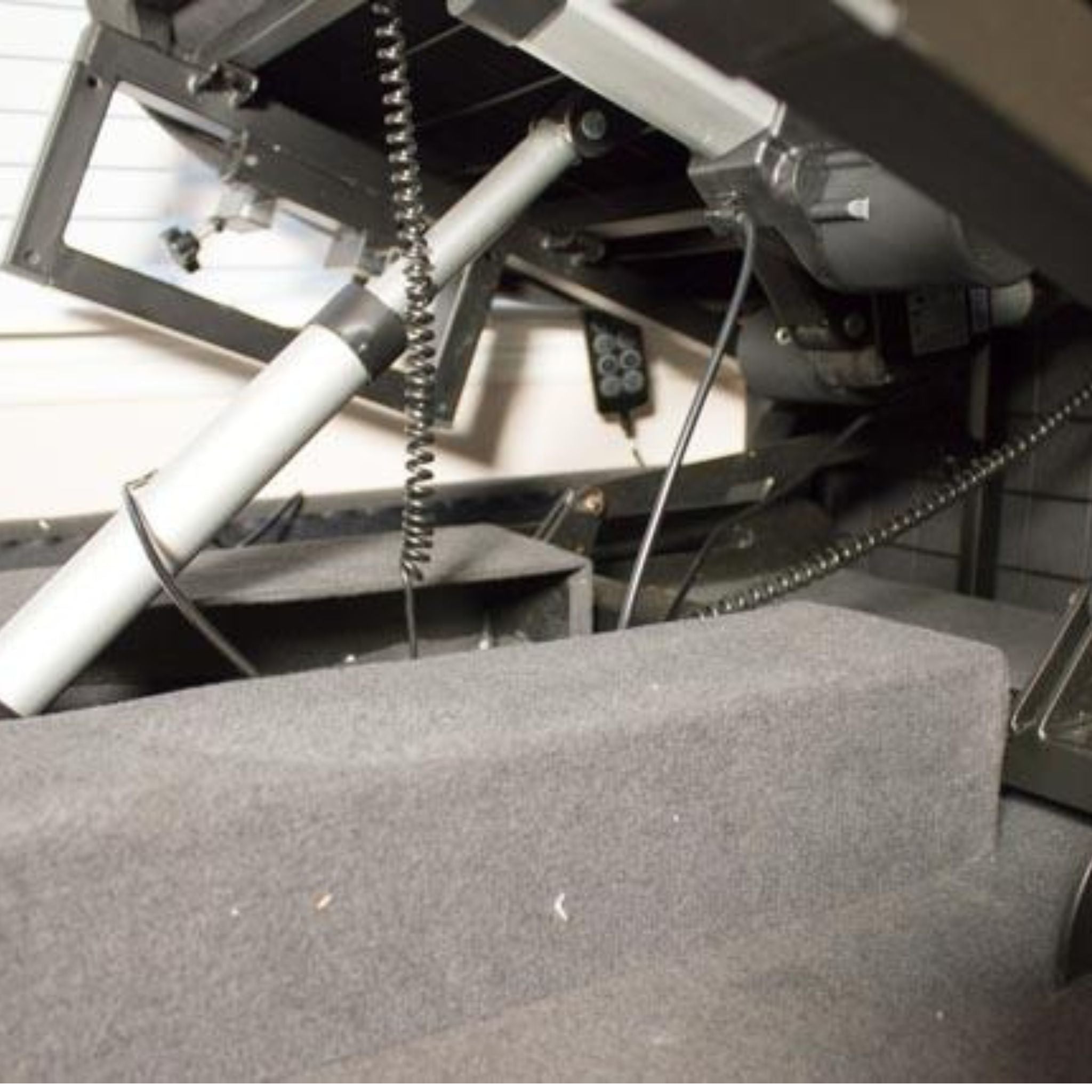 Close-up underside view of the ENVYY Sleep-to-Stand adjustable bed by Platinum Health showing the reinforced steel frame, electric lift actuators, and powered positioning system engineered for smooth transitions and long-term durability.