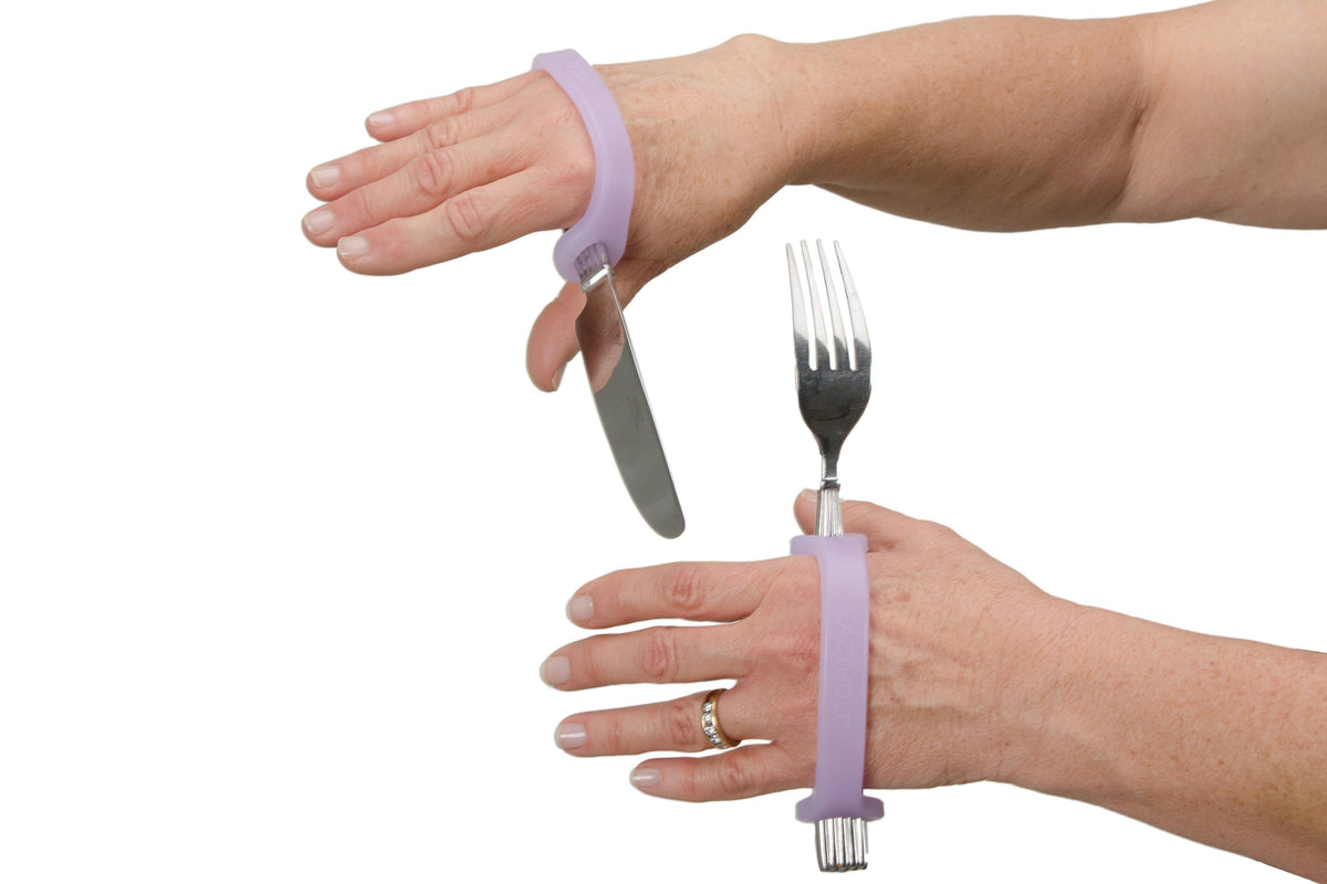 Two hands using lavender EaZyHold cuffs to hold a fork and knife for independent eating
