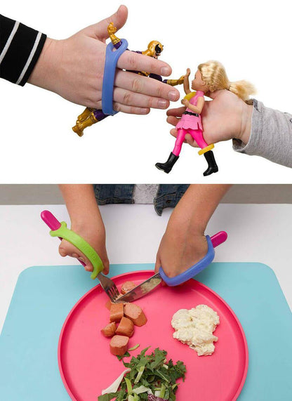 Child gripping action figures with blue and green EaZyHold cuffs, and using cuffs to hold a fork and knife while eating from a plate