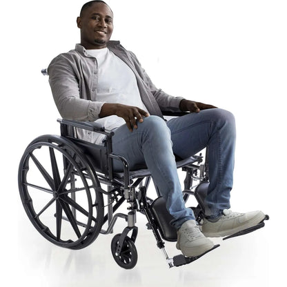 Adult seated in a Chariot II extra-wide bariatric wheelchair with elevating leg rests and reinforced frame designed for comfortable high-weight-capacity mobility support.