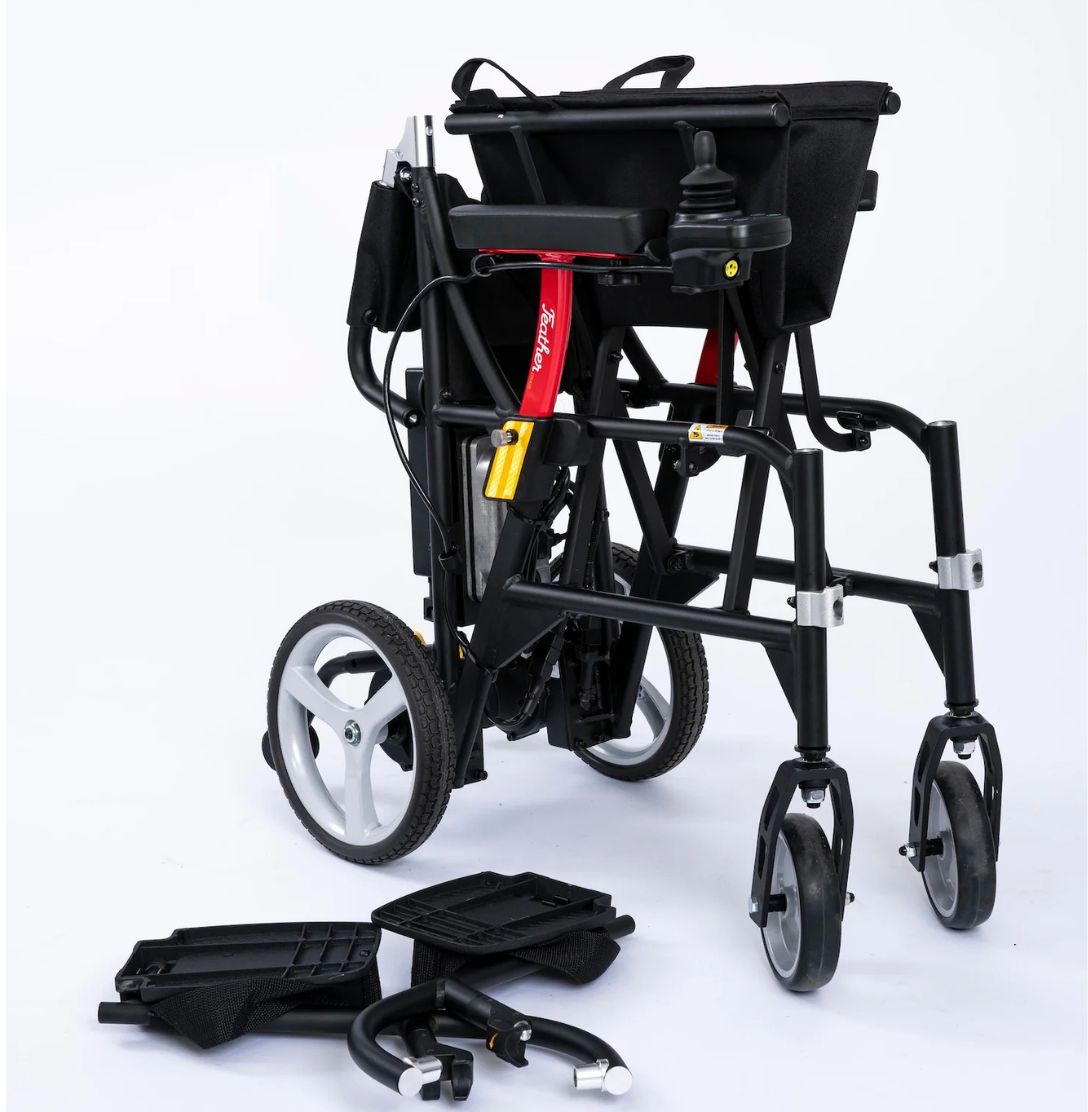 Feather Power Chair folded upright with its two swing-away footrests detached and placed in front