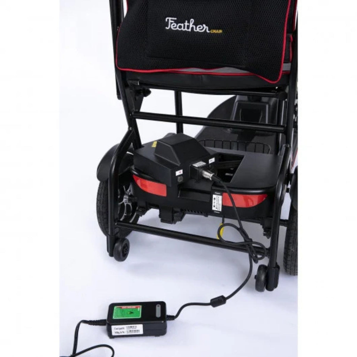 Feather Scooter battery charging on the scooter with the included charger plugged into the rear battery pack
