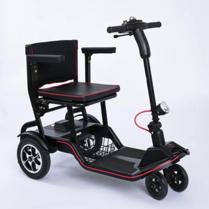 Feather Scooter 4-wheel folding mobility scooter, three-quarter front view with padded seat, flip-back armrests, front basket, and headlight