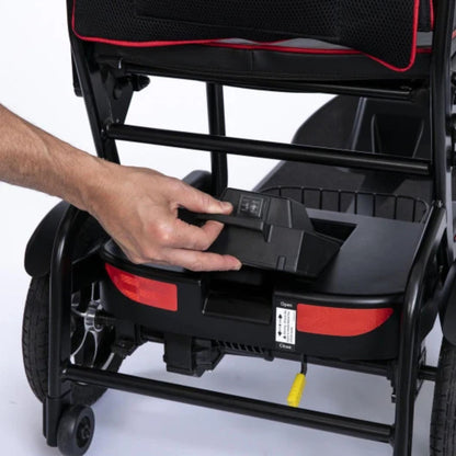 Hand lifting the removable lithium battery pack by its handle from the rear of the Feather Scooter