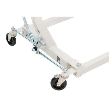 Close-up of the adjustable base legs, swivel casters, and width-adjustment linkage on a Hoyer lift