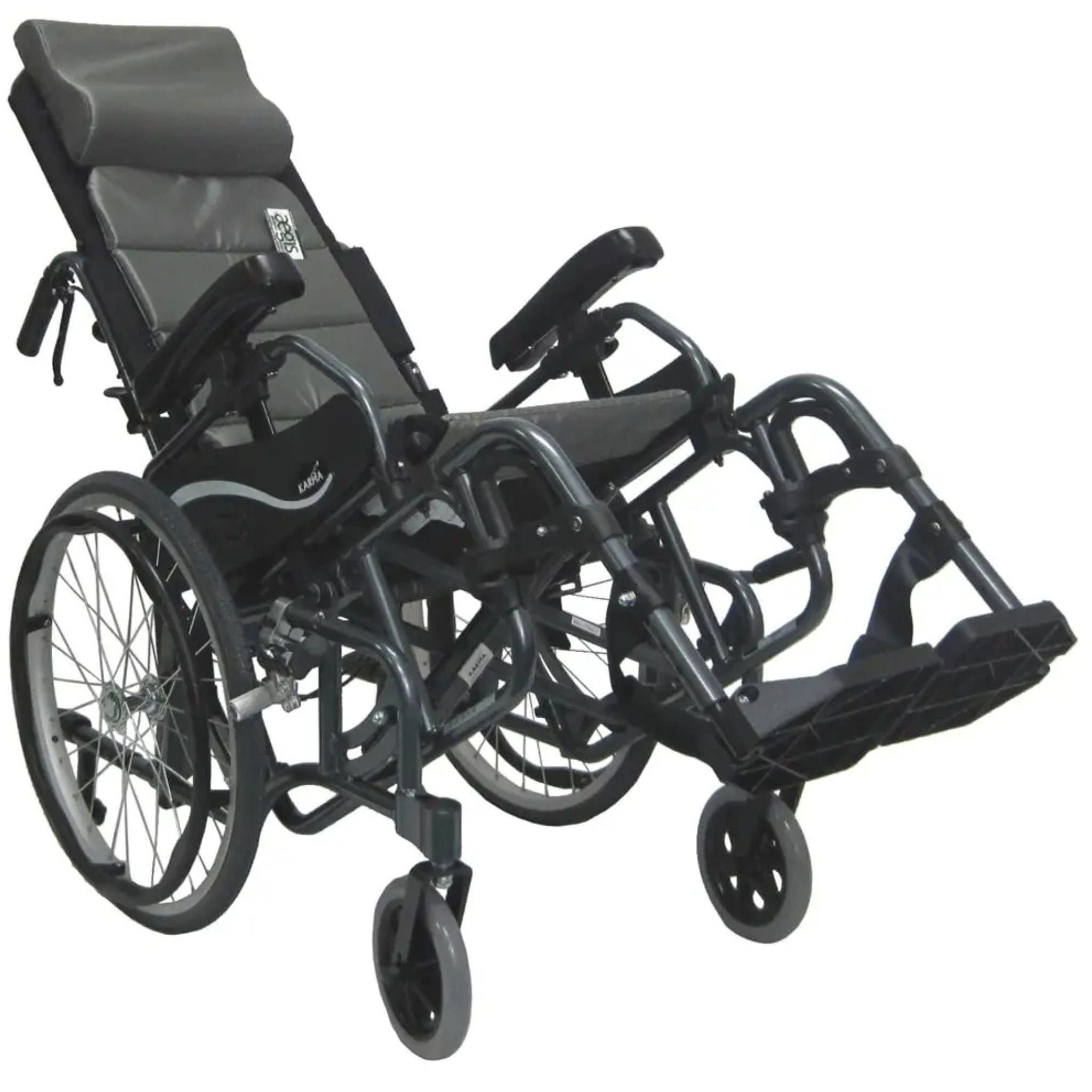Karman VIP-515 manual propel tilt-in-space wheelchair shown in a tilted pressure relief position with elevated leg rests, padded headrest, and 20-inch rear wheels on a white background