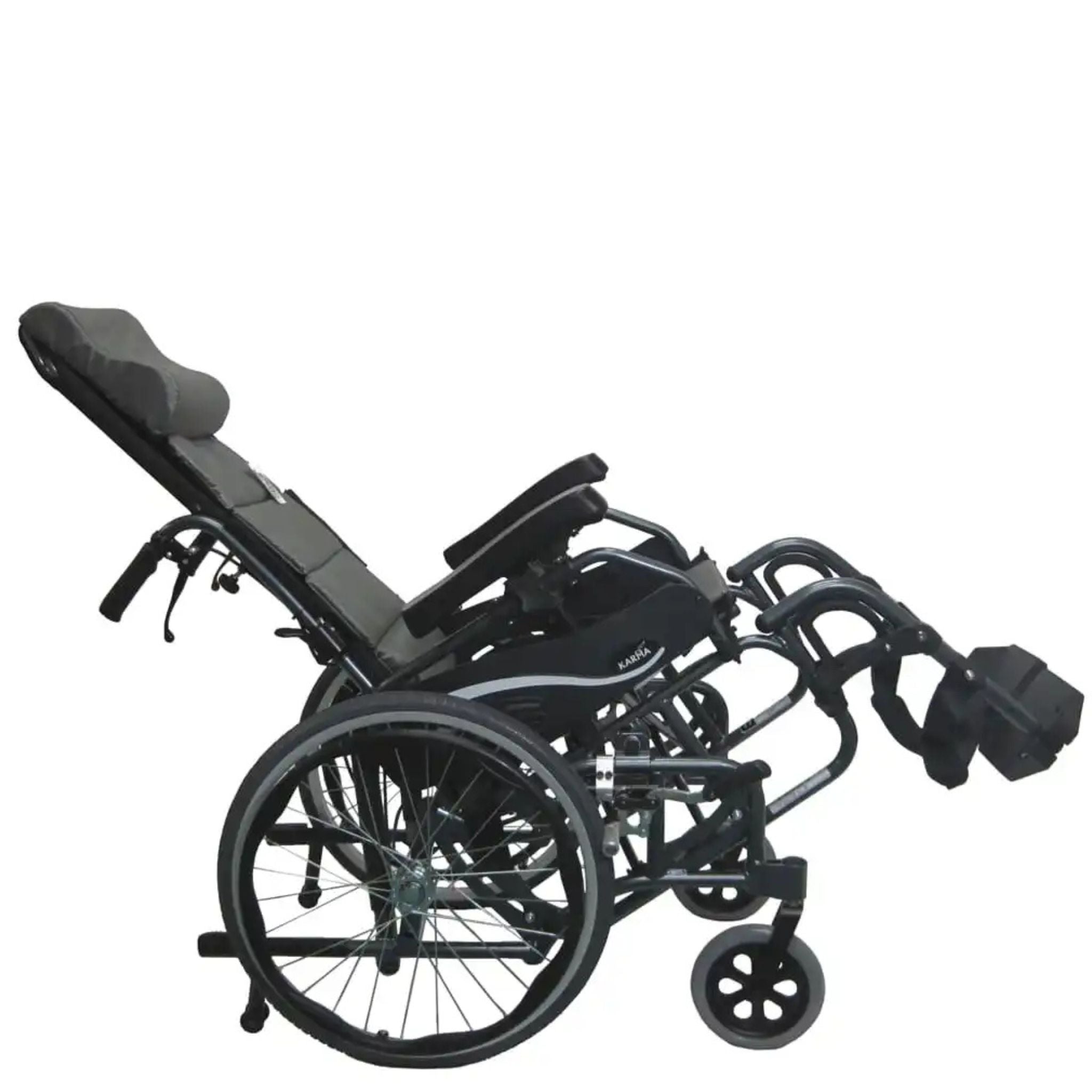 Side view of the Karman VIP-515 manual propel tilt-in-space wheelchair in a reclined pressure relief position with elevated leg rests and ergonomic headrest on a white background