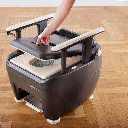 Caregiver lifting the Wrappon ORB seat panel to access the film cartridge inside